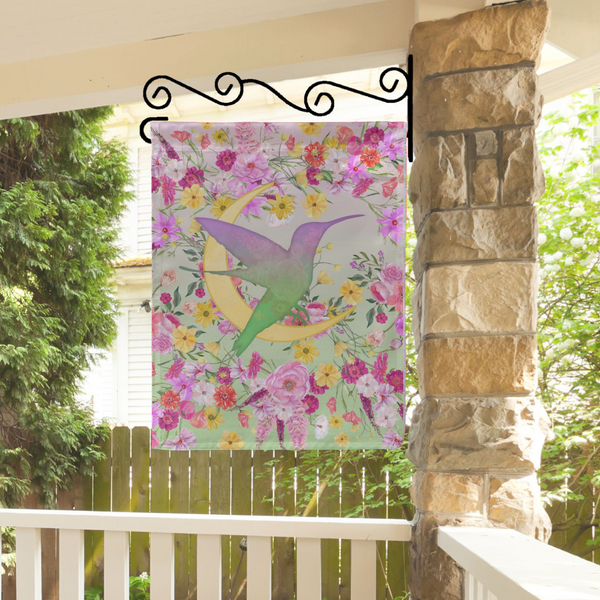 a picture of a hummingbird on a wall hanging on a porch