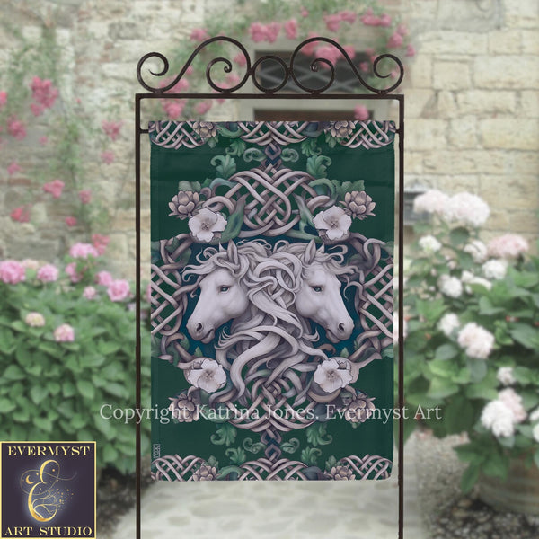 a decorative banner with a floral design and two white horses, placed in front of a stone wall with pink flowers.