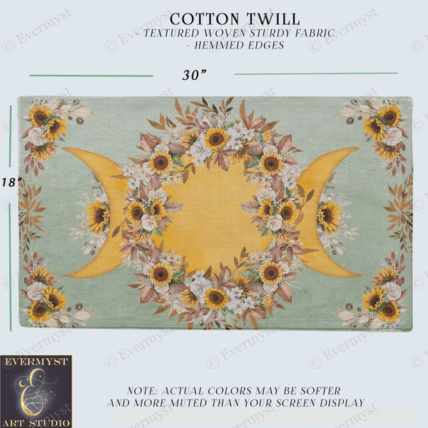 The image is a printed fabric with a floral design featuring sunflowers and crescent moons. The fabric has a textured woven appearance and is described as a cotton twill with hemed edges.