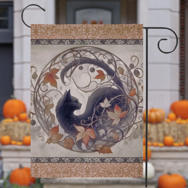 a black cat sitting on top of a table next to pumpkins