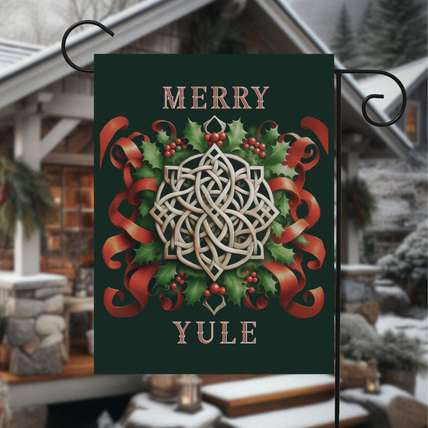 a merry yule sign hanging from a metal pole
