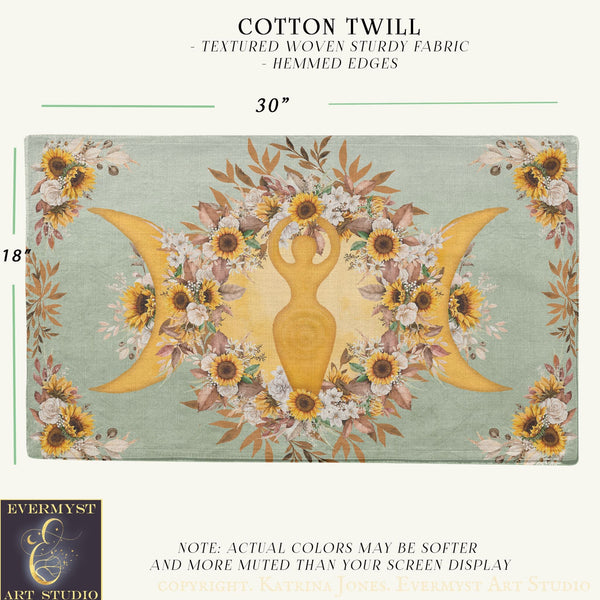 The image is a textile featuring a floral design with a central figure surrounded by sunflowers and other flowers. The design is framed by a border of leaves and flowers, creating a decorative and textured appearance.