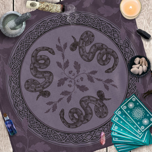 a table topped with a purple cloth covered in snakes